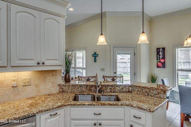 kitchen featuring stainless steel dishwasher, crown molding, a sink, and tile patterned floors