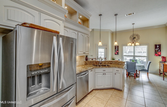 kitchen with a chandelier, light tile patterned flooring, stainless steel appliances, a peninsula, and a sink