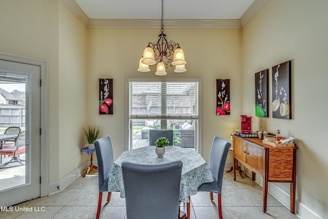 dining space featuring a chandelier, crown molding, baseboards, and light tile patterned floors