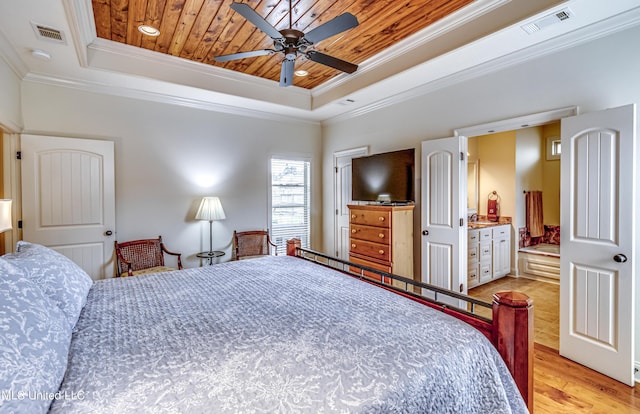 bedroom with a tray ceiling, visible vents, ornamental molding, light wood-style floors, and wood ceiling