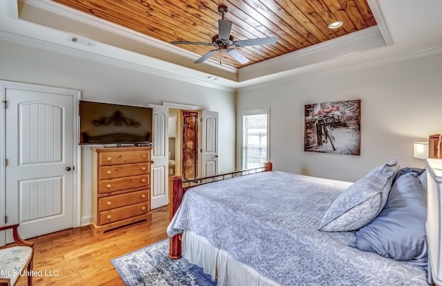 bedroom featuring visible vents, wood ceiling, a tray ceiling, crown molding, and light wood-style floors