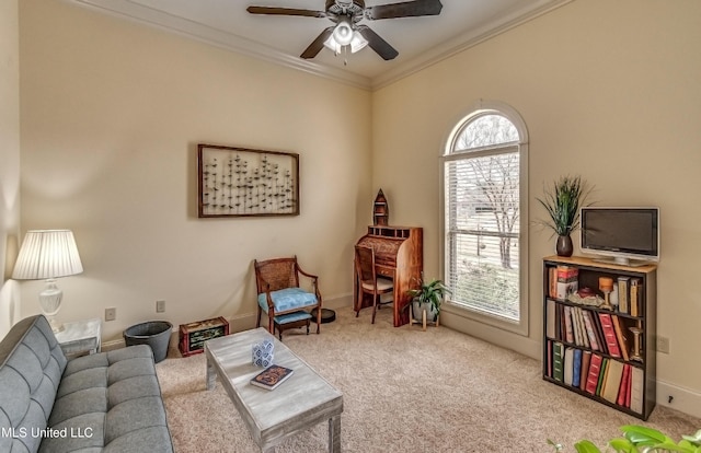 sitting room featuring ornamental molding, carpet, and a ceiling fan