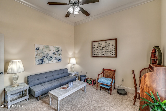 carpeted living area featuring ornamental molding, baseboards, and a ceiling fan