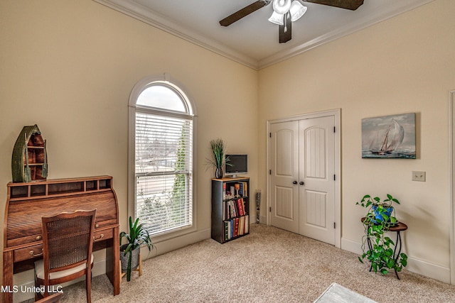 home office with carpet floors, a ceiling fan, and crown molding