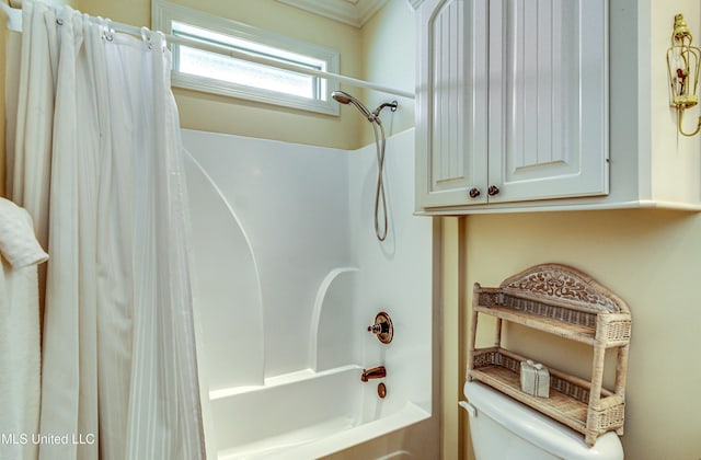 bathroom featuring toilet and shower / bathtub combination with curtain