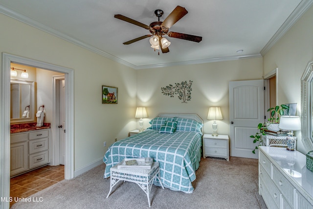 bedroom featuring ensuite bathroom, light carpet, a ceiling fan, baseboards, and crown molding