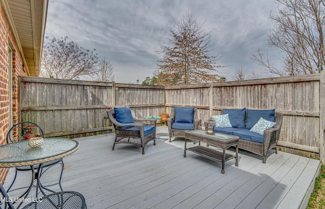 deck featuring outdoor lounge area and a fenced backyard