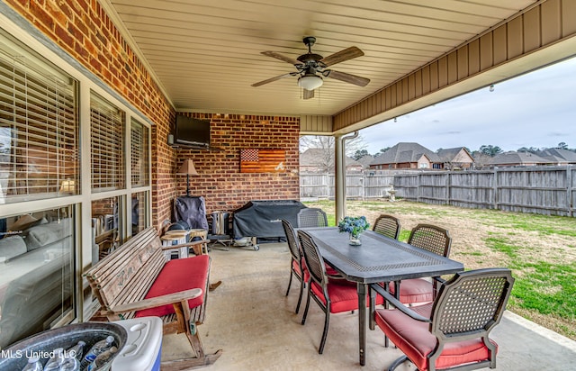 view of patio featuring outdoor dining space, a fenced backyard, ceiling fan, and grilling area