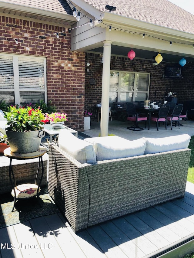 wooden deck featuring outdoor dining area and an outdoor living space