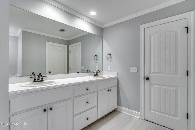 bathroom with double vanity, ornamental molding, and a sink