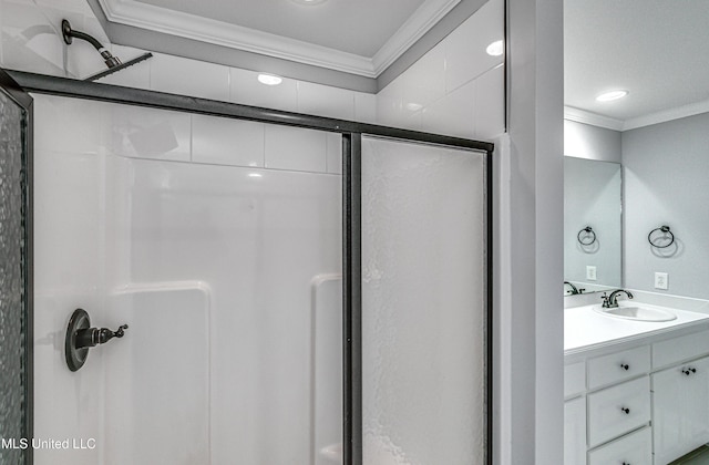 bathroom with vanity, a stall shower, and crown molding