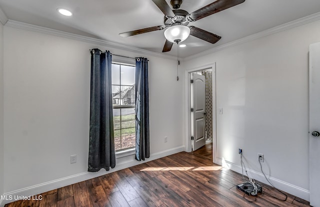 spare room with a wealth of natural light, crown molding, and wood-type flooring