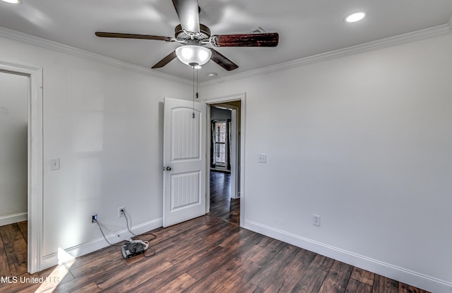 unfurnished room with dark wood-style floors, baseboards, and ornamental molding