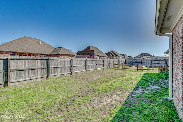 view of yard featuring a residential view and a fenced backyard