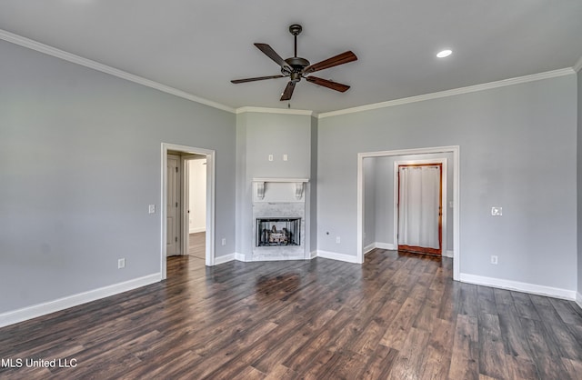 unfurnished living room with crown molding, dark wood-style floors, a fireplace, and baseboards