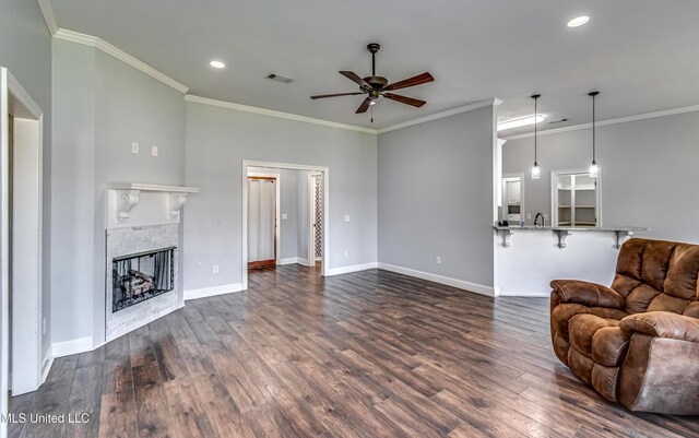 living room featuring dark wood-type flooring, baseboards, visible vents, and a tile fireplace