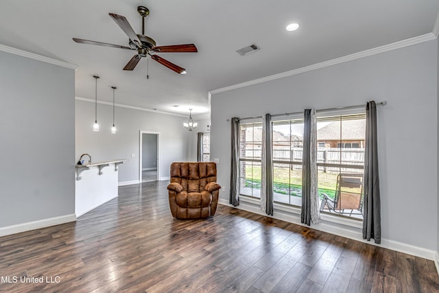 living area featuring visible vents, baseboards, dark wood finished floors, and ornamental molding