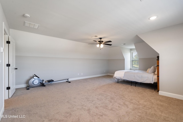 unfurnished bedroom with vaulted ceiling, light carpet, and ceiling fan