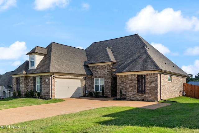 french provincial home with a garage and a front lawn