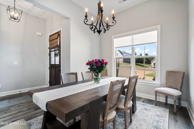 dining space featuring a notable chandelier and hardwood / wood-style flooring