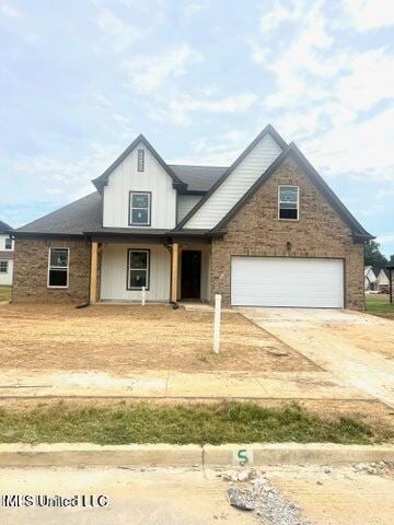 view of front of property with board and batten siding and concrete driveway