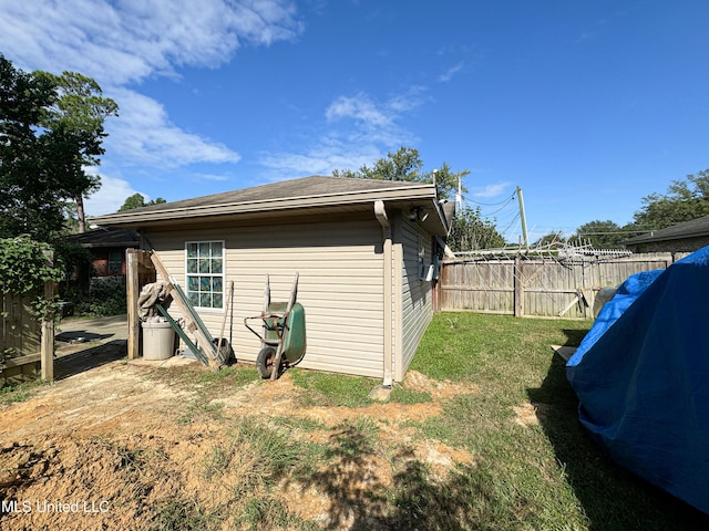 view of side of home featuring a yard