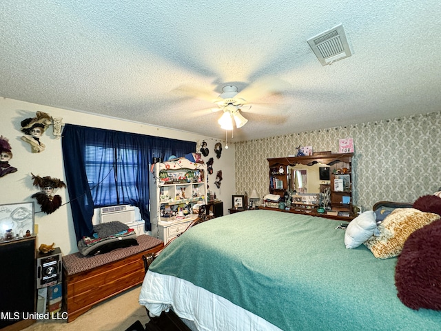 bedroom with ceiling fan, a textured ceiling, and cooling unit