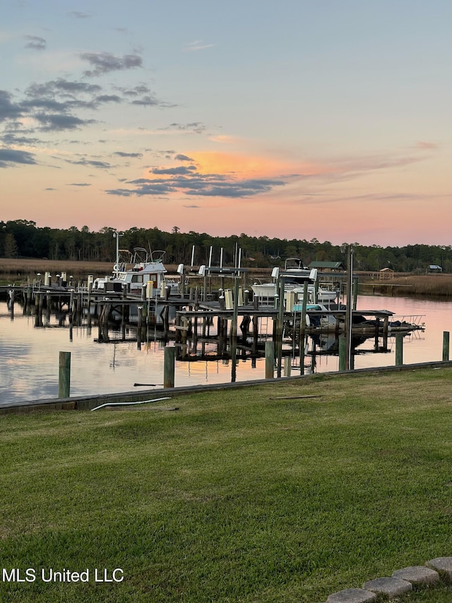 view of dock featuring a yard and a water view