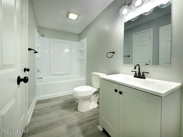 full bathroom with toilet, wood-type flooring, vanity, and bathtub / shower combination