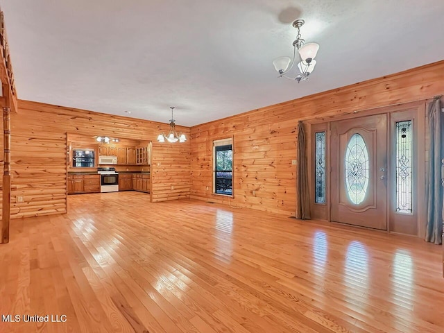 159 Vard Sullivan Rd, Pinola, MS 39149 - foyer entrance featuring light wood-type flooring, wooden walls, and a chandelier