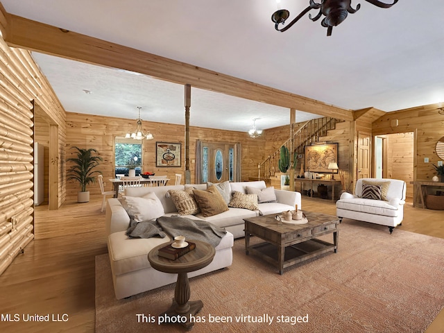 159 Vard Sullivan Rd, Pinola, MS 39149 - living room with beam ceiling, wood finished floors, stairway, ceiling fan with notable chandelier, and wooden walls