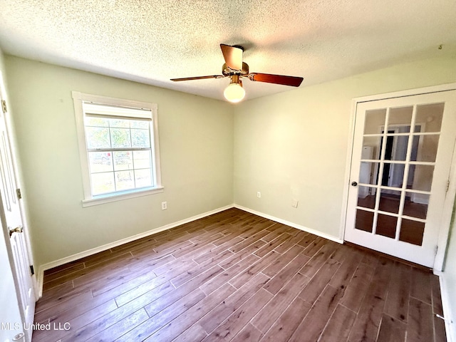 2006 Eden St, Pascagoula, MS 39581 - spare room featuring dark wood-style flooring, a ceiling fan, a textured ceiling, and baseboards