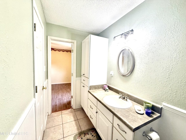 2006 Eden St, Pascagoula, MS 39581 - bathroom with a textured ceiling, tile patterned floors, vanity, and a textured wall