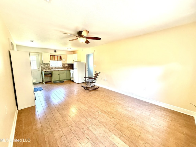 2006 Eden St, Pascagoula, MS 39581 - unfurnished living room with wood finished floors, ceiling fan, baseboards, and a sink