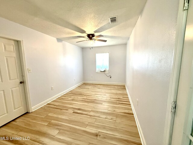 2006 Eden St, Pascagoula, MS 39581 - spare room with a ceiling fan, light wood-style flooring, baseboards, and a textured ceiling