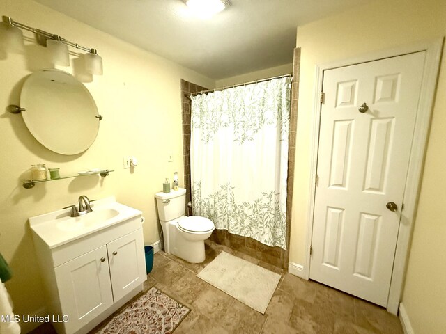 2006 Eden St, Pascagoula, MS 39581 - bathroom with toilet, vanity, a shower with shower curtain, and baseboards