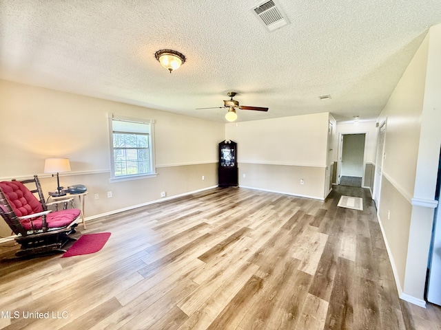 2006 Eden St, Pascagoula, MS 39581 - living area featuring a textured ceiling, wood finished floors, a ceiling fan, and baseboards