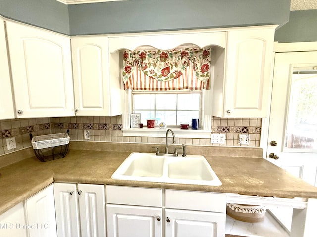 2006 Eden St, Pascagoula, MS 39581 - kitchen with a sink, backsplash, and white cabinets