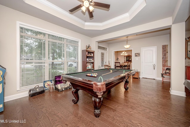 game room with a tray ceiling, wood finished floors, a ceiling fan, ornamental molding, and pool table