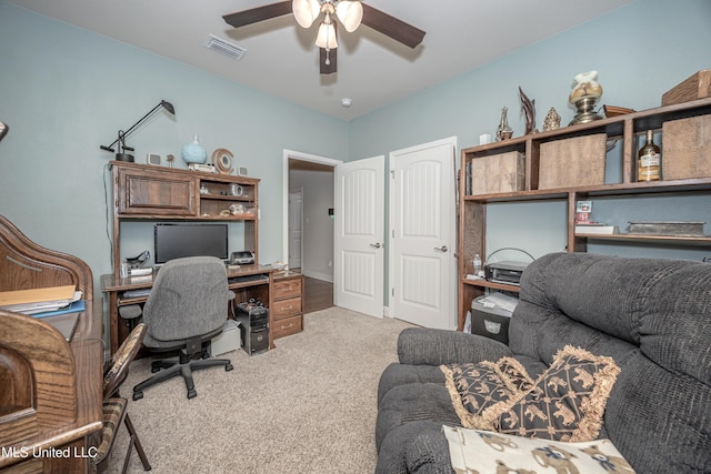 office featuring a ceiling fan, visible vents, and light colored carpet