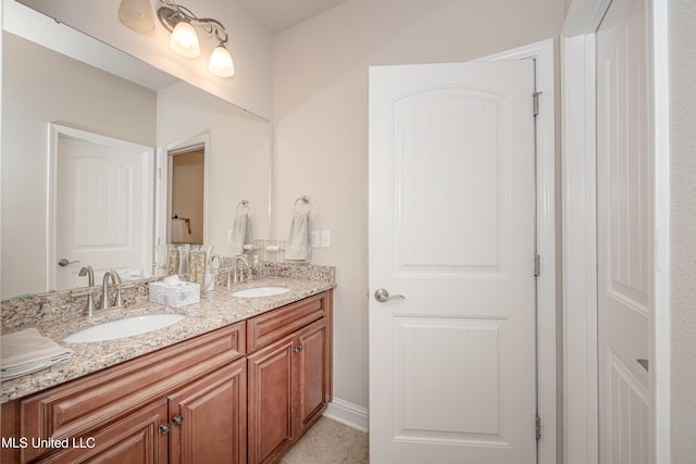 full bathroom featuring a sink and double vanity