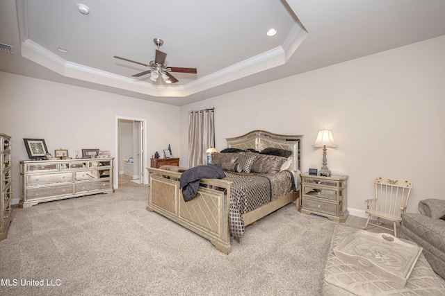 bedroom with light colored carpet, baseboards, ornamental molding, and a tray ceiling