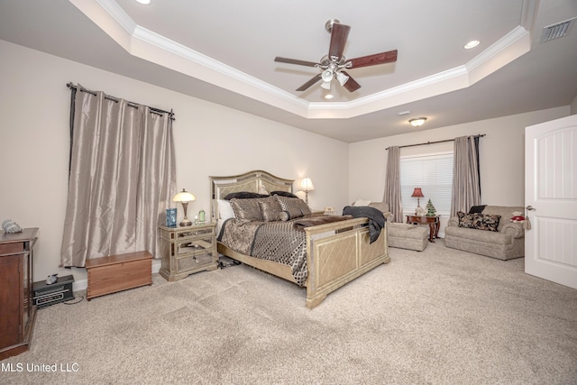 bedroom featuring carpet, a raised ceiling, and crown molding