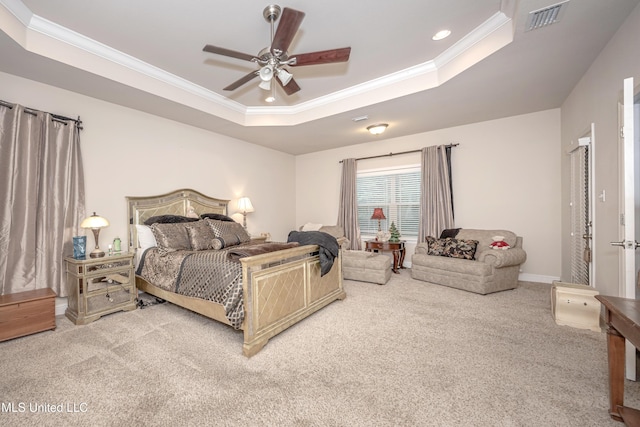 carpeted bedroom featuring recessed lighting, a tray ceiling, visible vents, crown molding, and baseboards