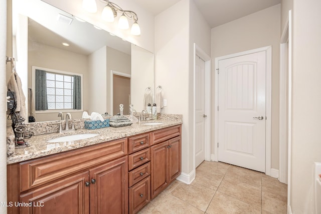 bathroom featuring double vanity, visible vents, tile patterned flooring, and a sink