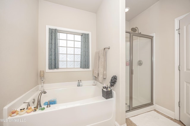 full bath with a shower stall and a garden tub