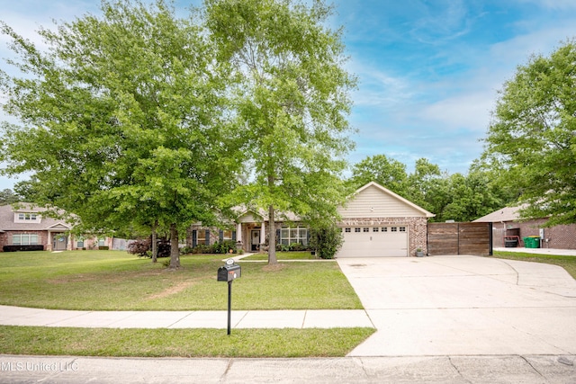 view of property hidden behind natural elements featuring a garage, driveway, a front lawn, and fence