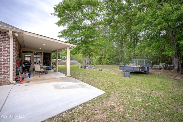 view of yard featuring fence and a patio