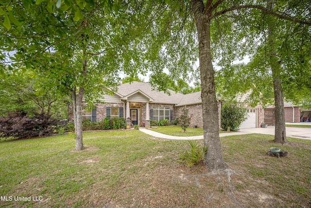 view of front of home with an attached garage, driveway, a front lawn, and brick siding