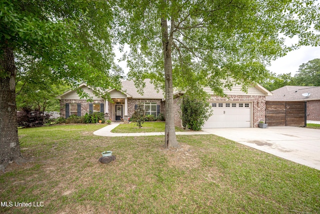 ranch-style house with driveway, fence, brick siding, a garage, and a front yard